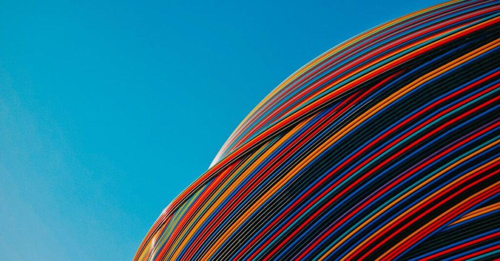 Vibrant striped architectural pavilion under a clear blue sky in Dubai. Modern design.